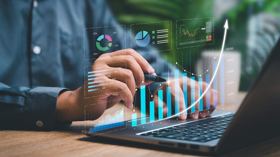 Illustration of numbers going up, man sitting in front of computer 